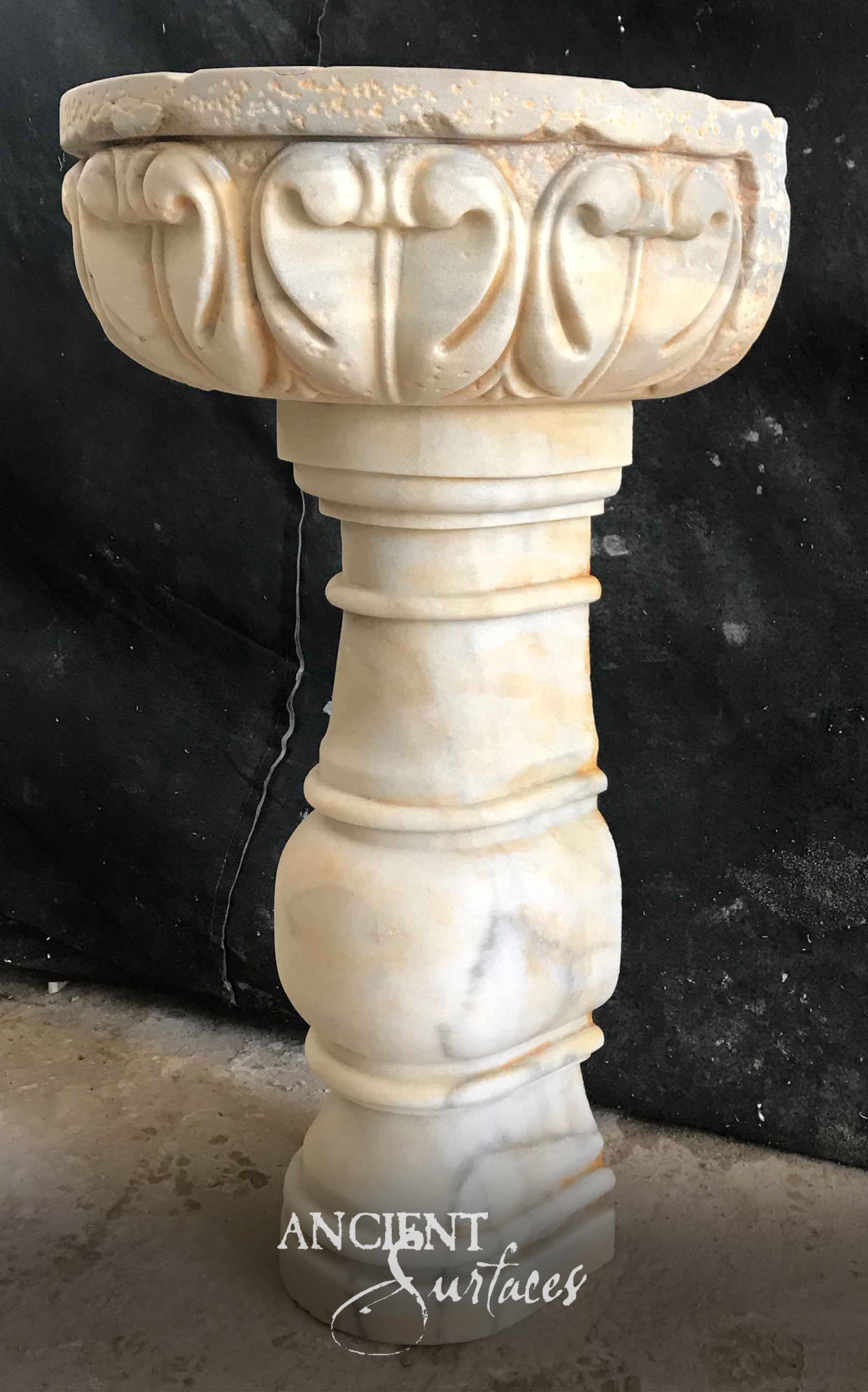 White marble pedestal basin with carved lotus-leaf rim on a turned baluster column